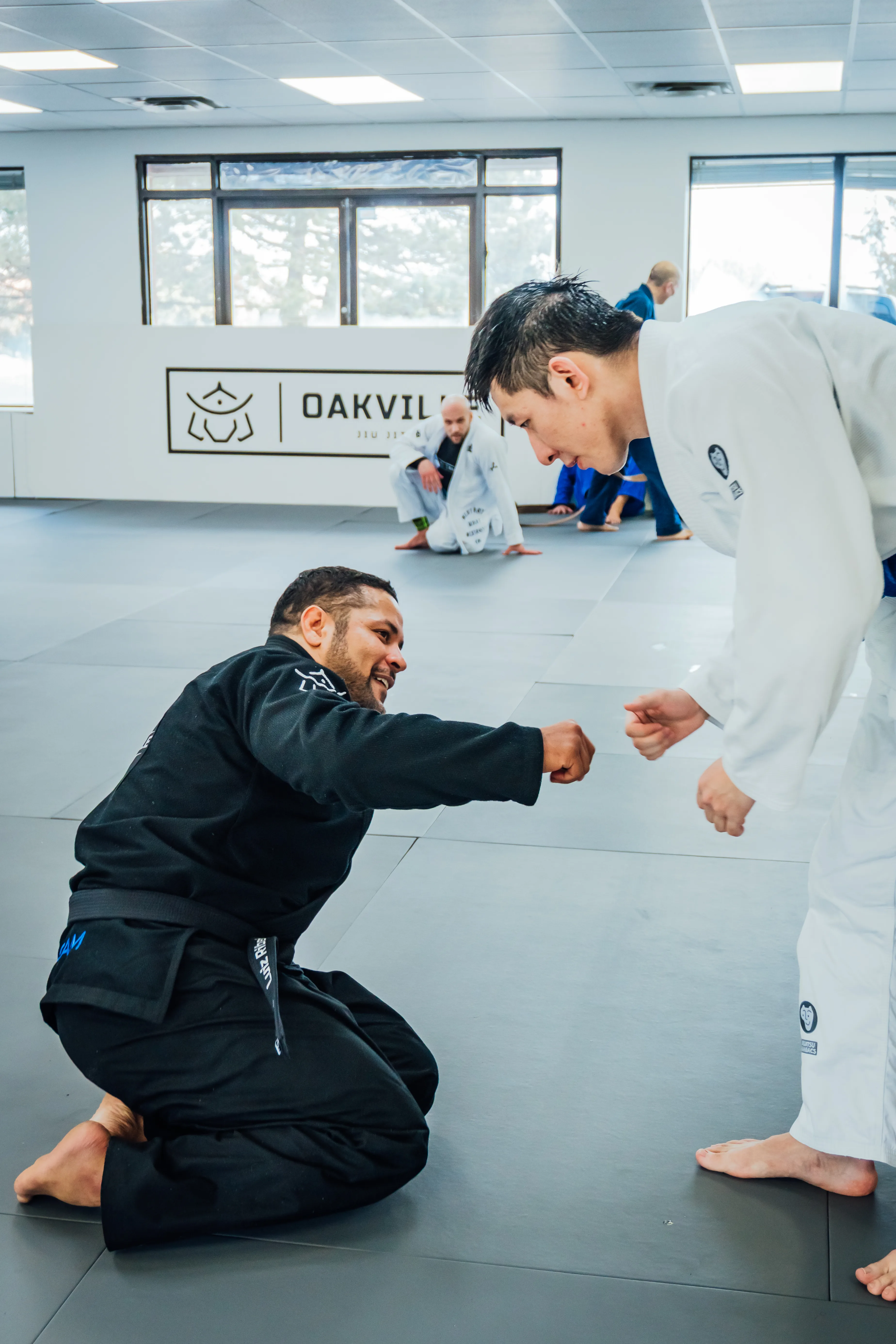 Students rolling live on the mat